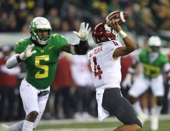 Oregon's Kayvon Thibodeaux, left, bears down on Washington State quarterback Jayden de Laura during the first half.
